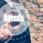 Businessman selecting a Agenda Concept button